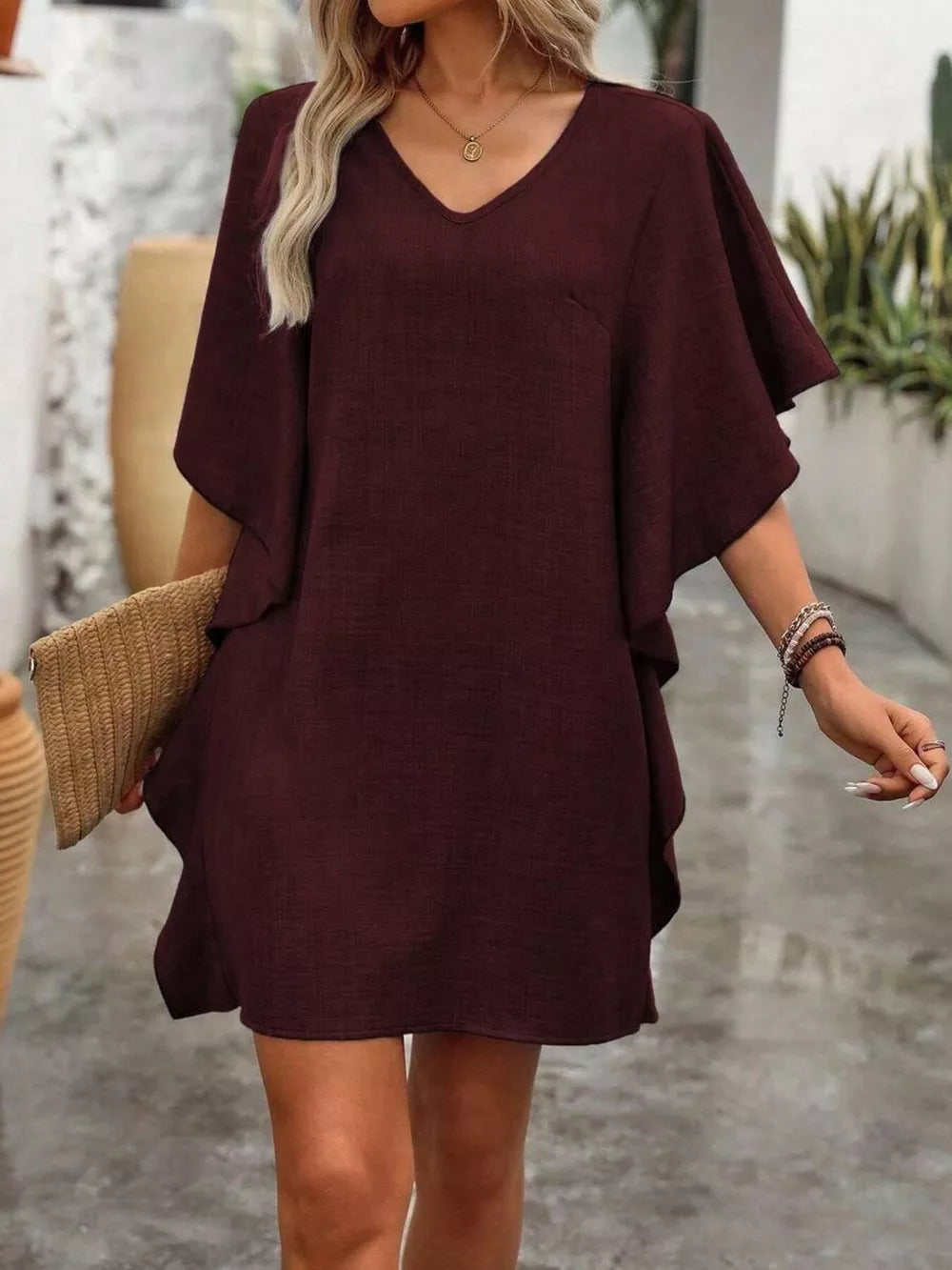 Burgundy mini dress with v-neck, ruffled sleeves, and a casual flowy fit.