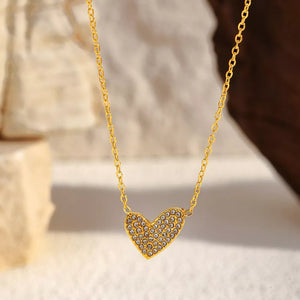 Gold necklace with a rhinestone-covered heart pendant