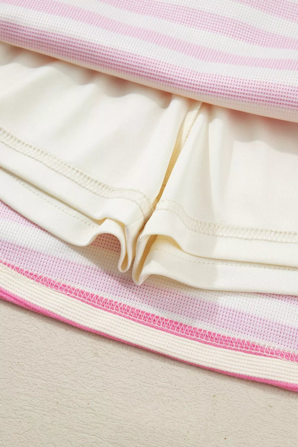 White and pink striped bikini bottoms with cream shorts detail