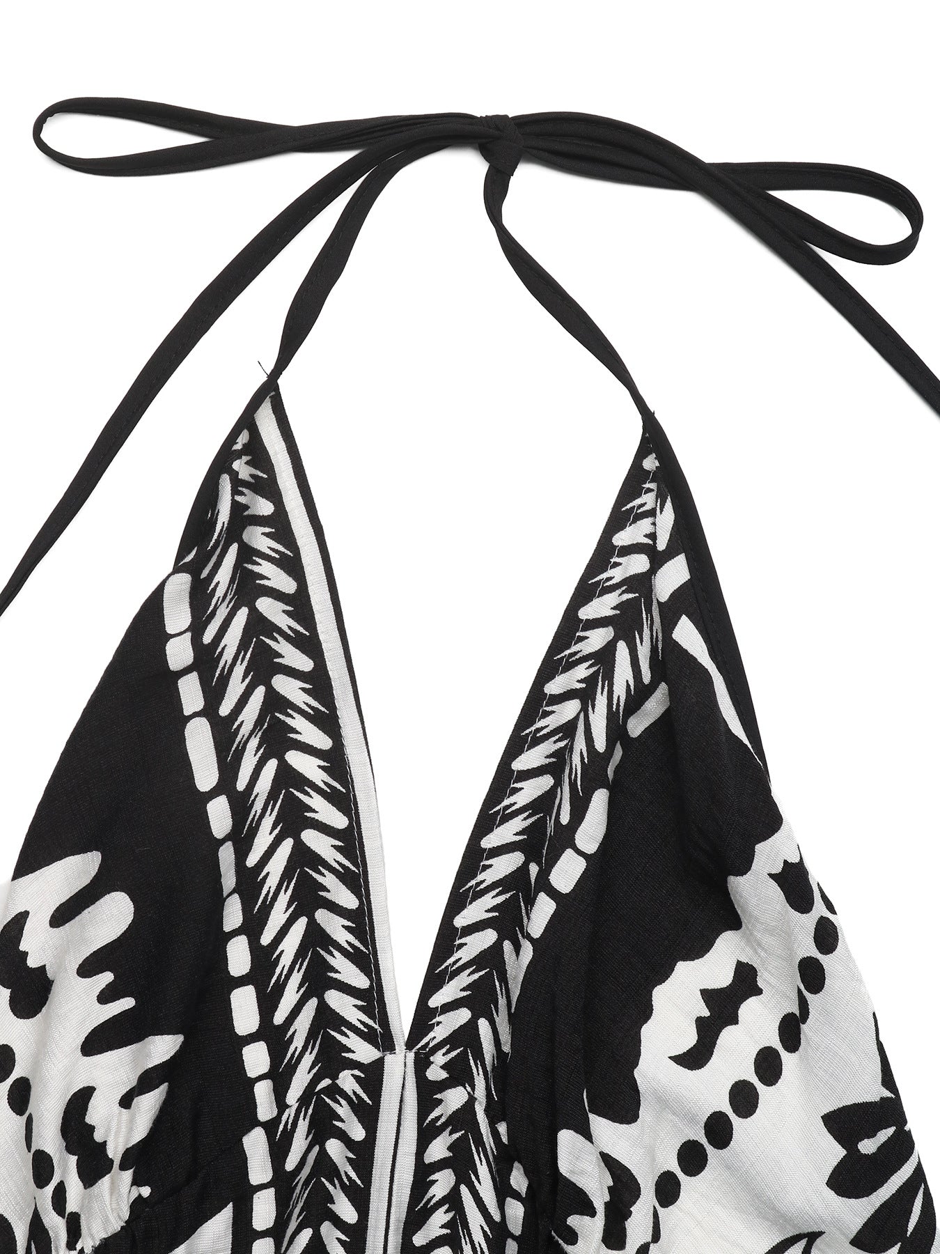 Black and white floral print halter neck maxi dress with deep V neckline and tie closure.