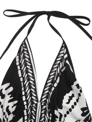 Black and white floral print halter neck maxi dress with deep V neckline and tie closure.