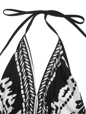 Black and white floral print halter neck maxi dress with deep V neckline and tie closure.