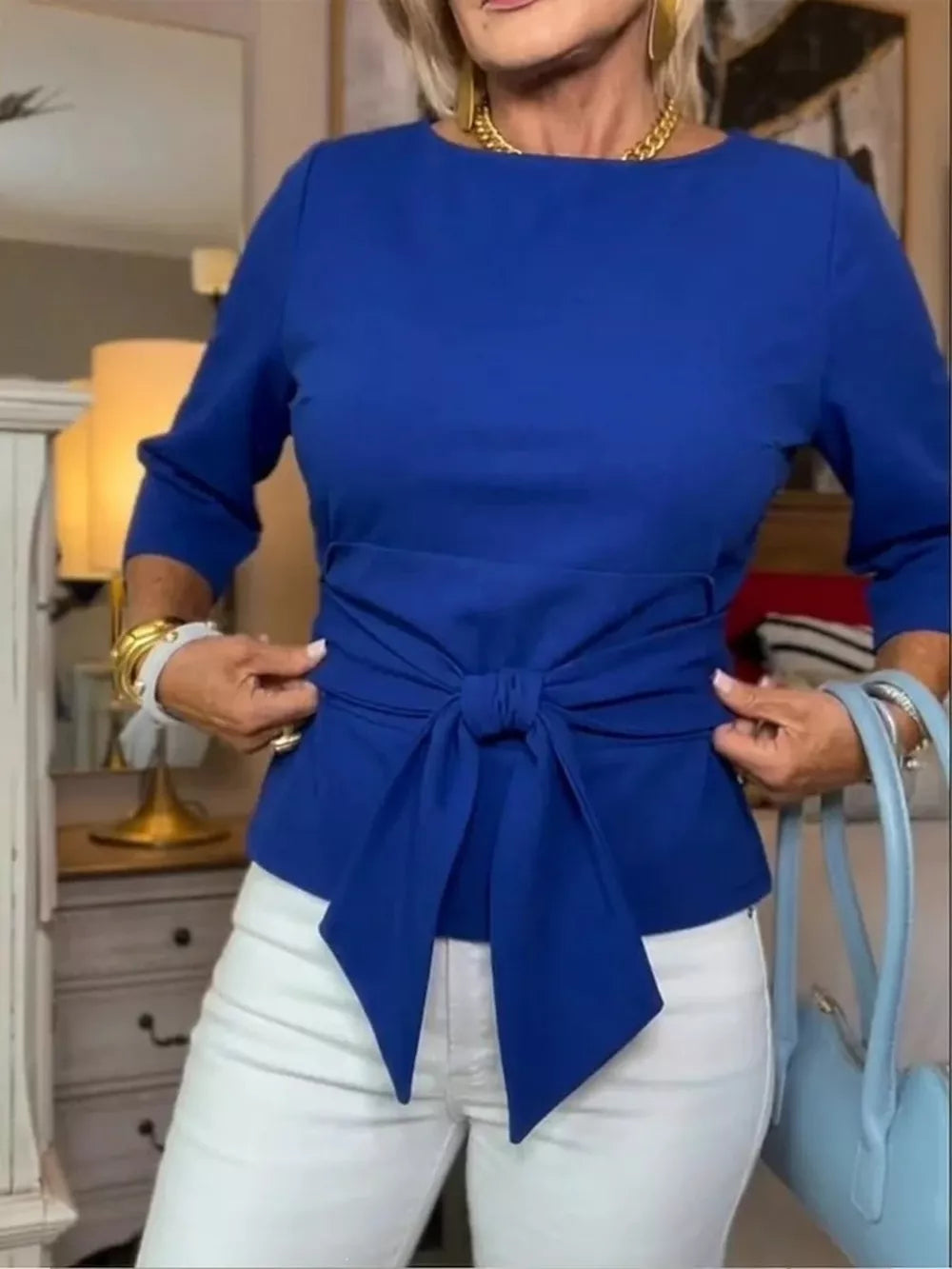 Blue 3/4 sleeve t-shirt with a tied waist detail, crew neck.