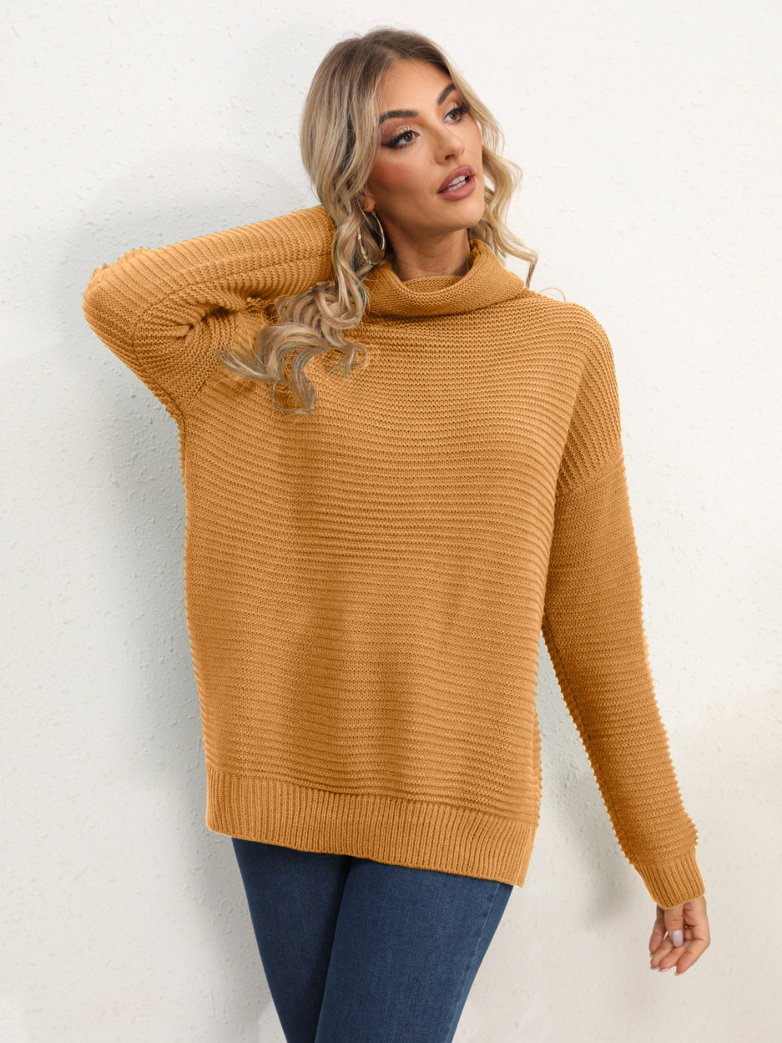 Textured knit oversized turtleneck pullover in mustard acrylic with a ribbed pattern.