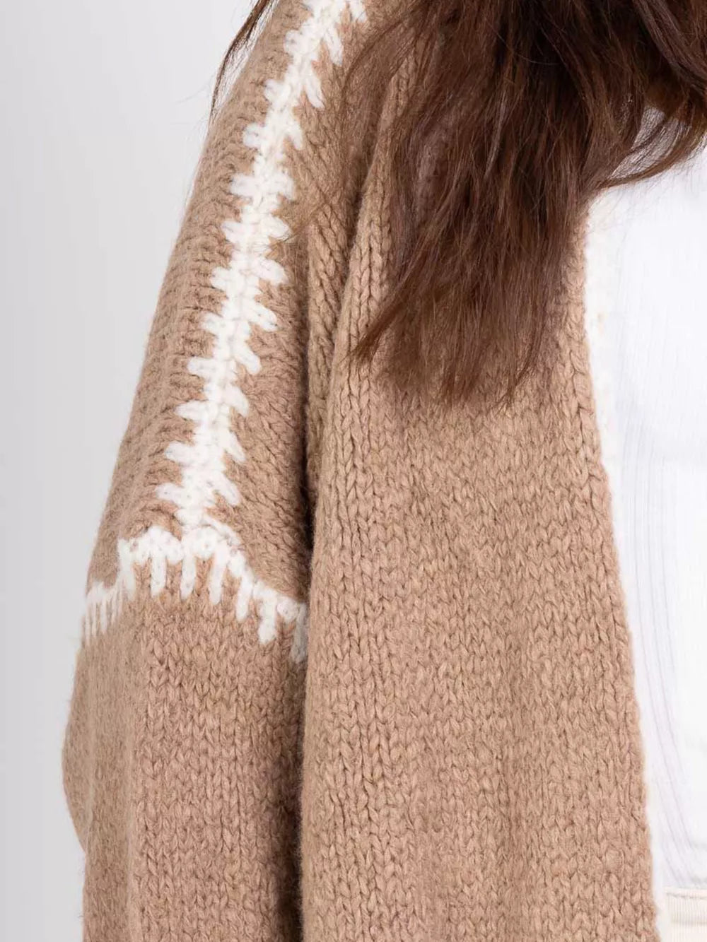Camel oversized cardigan with white contrast trim detail on the sleeve.