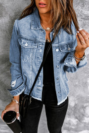 Blue distressed denim trucker jacket with frayed edges and distressed details.