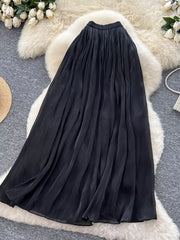 Black pleated maxi skirt with flowing fabric and a comfortable fit.