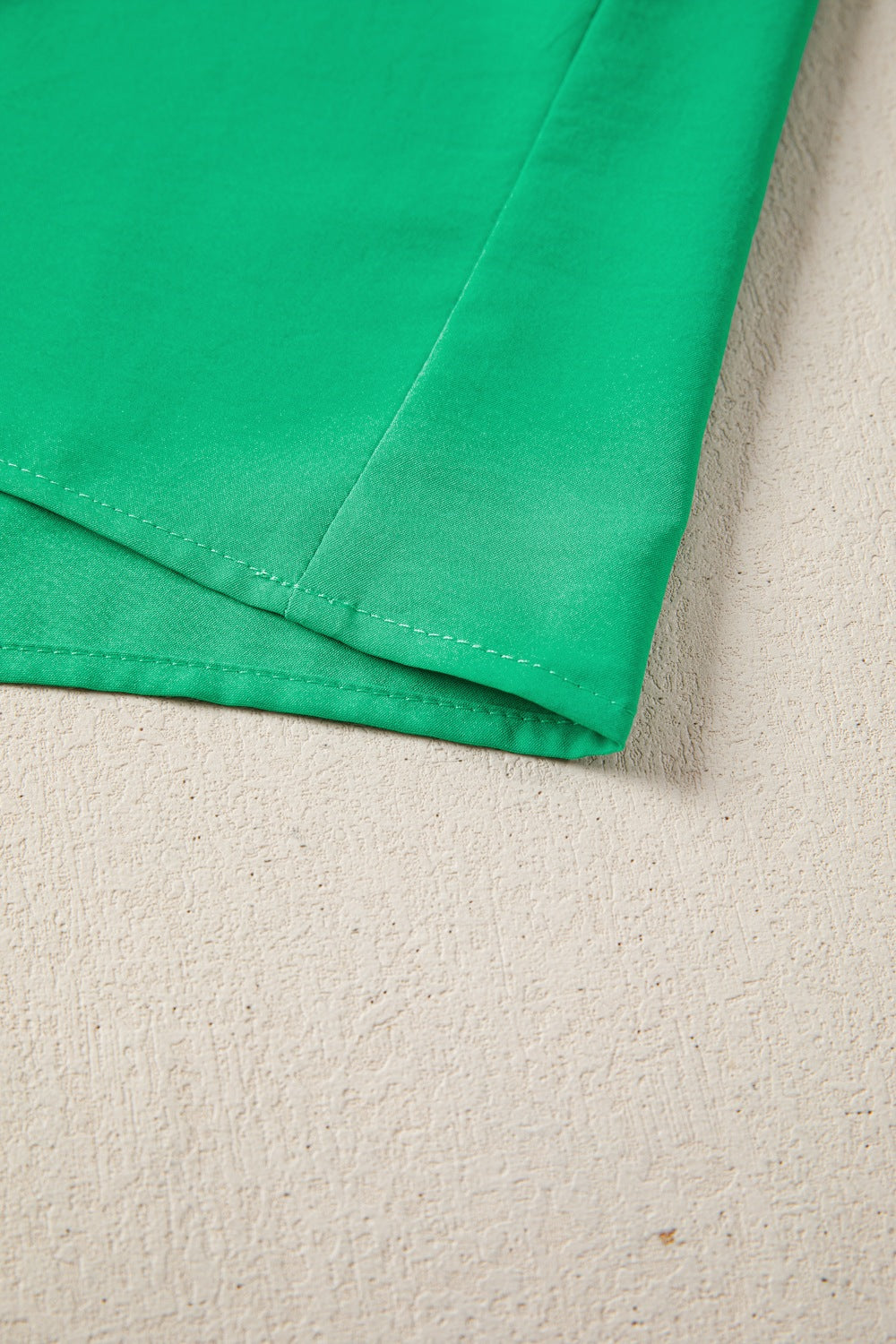 Green maxi dress with puff sleeves, showing seam detail.