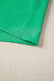 Green maxi dress with puff sleeves, showing seam detail.