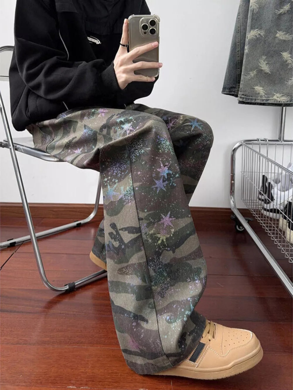 Camouflage wide-leg jeans with colorful star accents and a button fly.