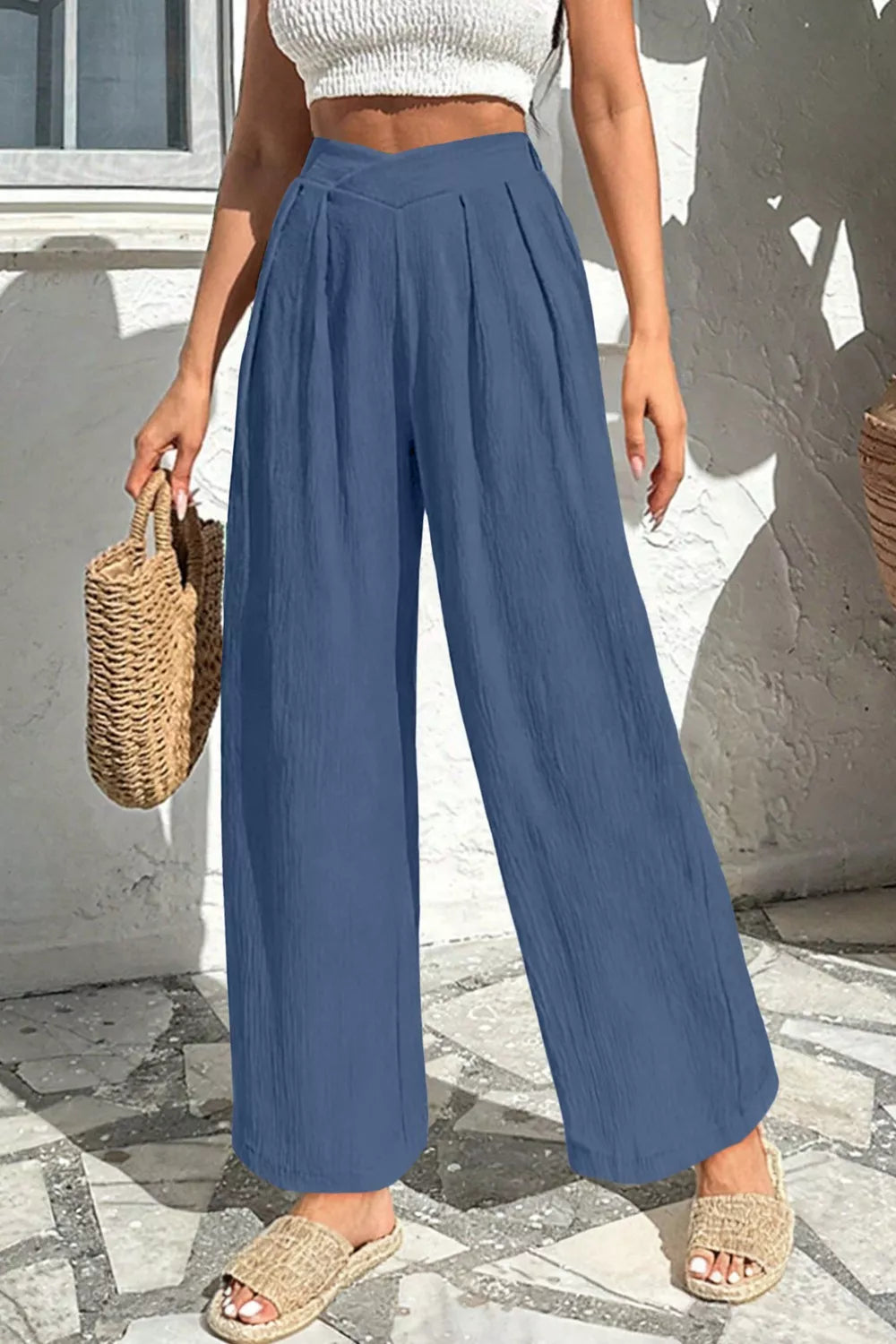 Textured wide-leg maternity pants in dusty blue with a crossed waist and pleats.