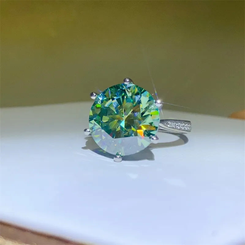 Silver ring with large green prismatic cut solitaire and small stones on band