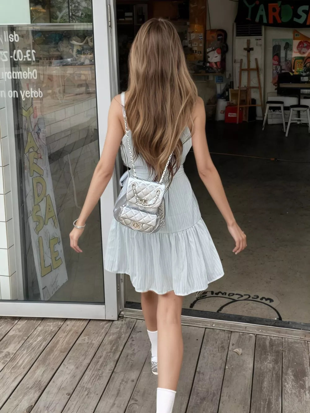 Sky blue mini dress with halter neckline and tiered skirt, tied waist detail