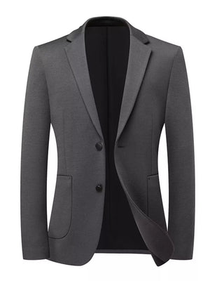 Dark gray acrylic two-button men's blazer with lapel collar and flap pockets.