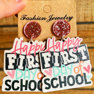 Graduation stacked book drop earrings with glitter tops and "Happy First Day of School" text.