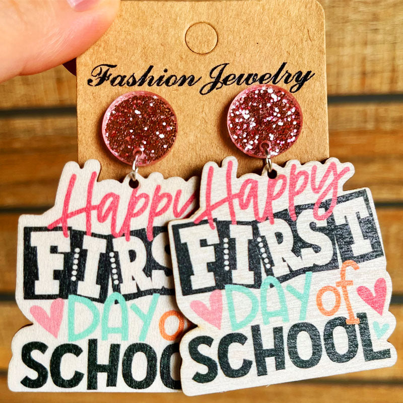 Graduation stacked book drop earrings with glitter tops and "Happy First Day of School" text.