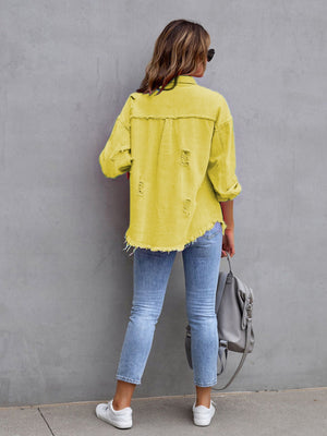 Yellow distressed denim shacket with frayed hem and cuffs, styled with jeans.