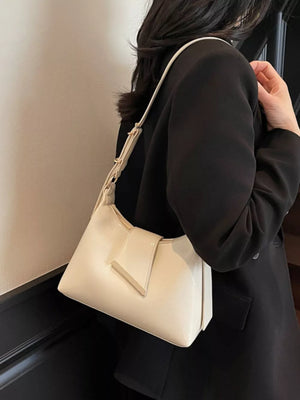 Beige crossbody bag with adjustable strap and gold accent closure.