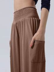 Coffee smocked waist harem pants with pockets and ankle cuffs.