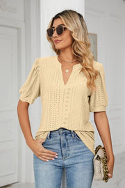Yellow perforated puff sleeve blouse with V-neck and keyhole detail.