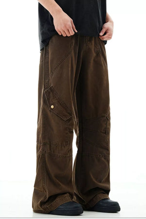 Brown cargo pants with snap pockets and detailed stitching.