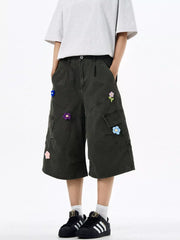 Dark Gray wide-leg cargo shorts with floral appliques and multiple pockets.