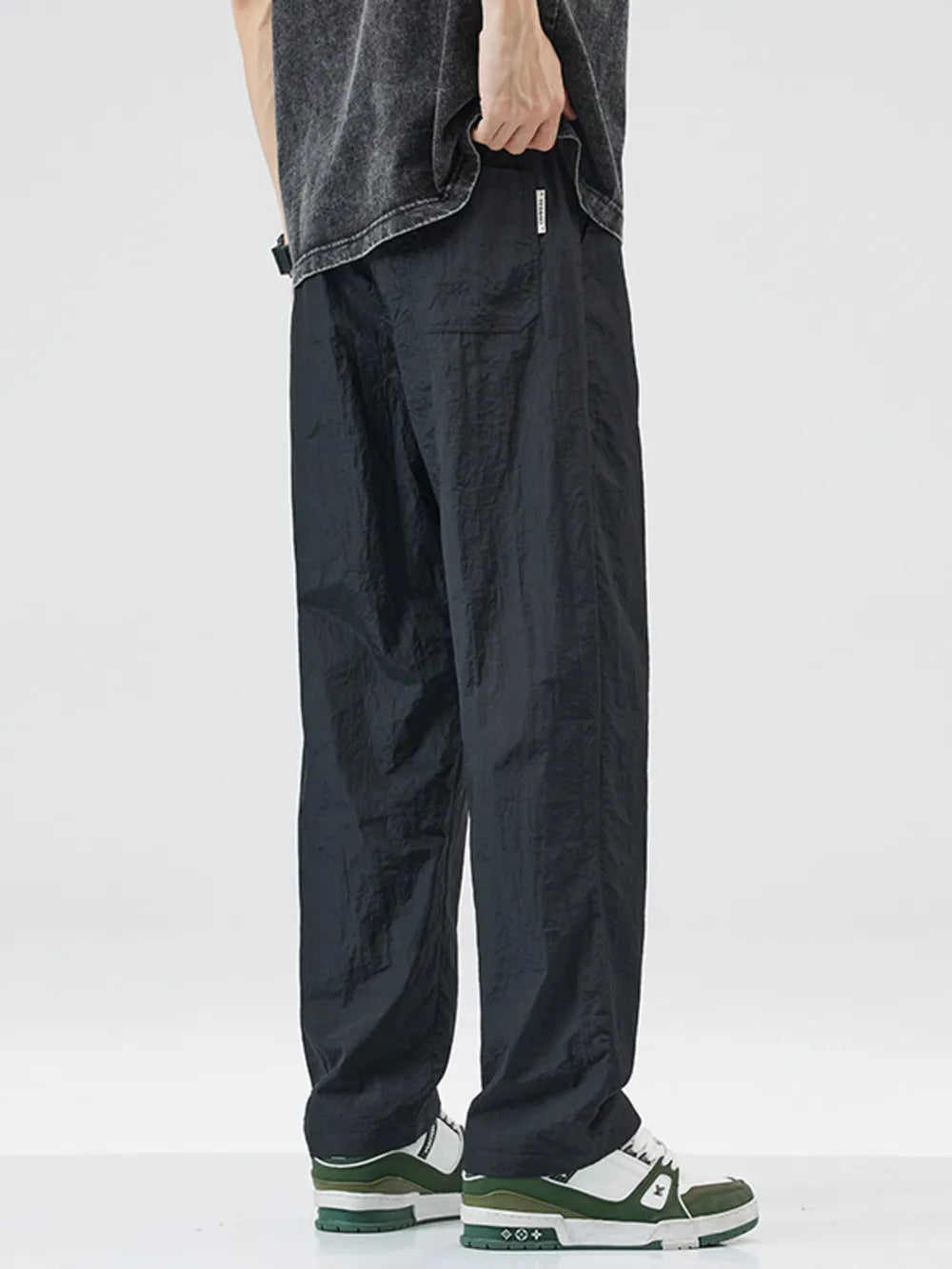 Black relaxed fit wide-leg casual sweatpants with pockets and a drawstring waist.