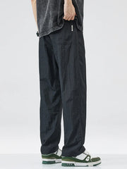Black relaxed fit wide-leg casual sweatpants with pockets and a drawstring waist.