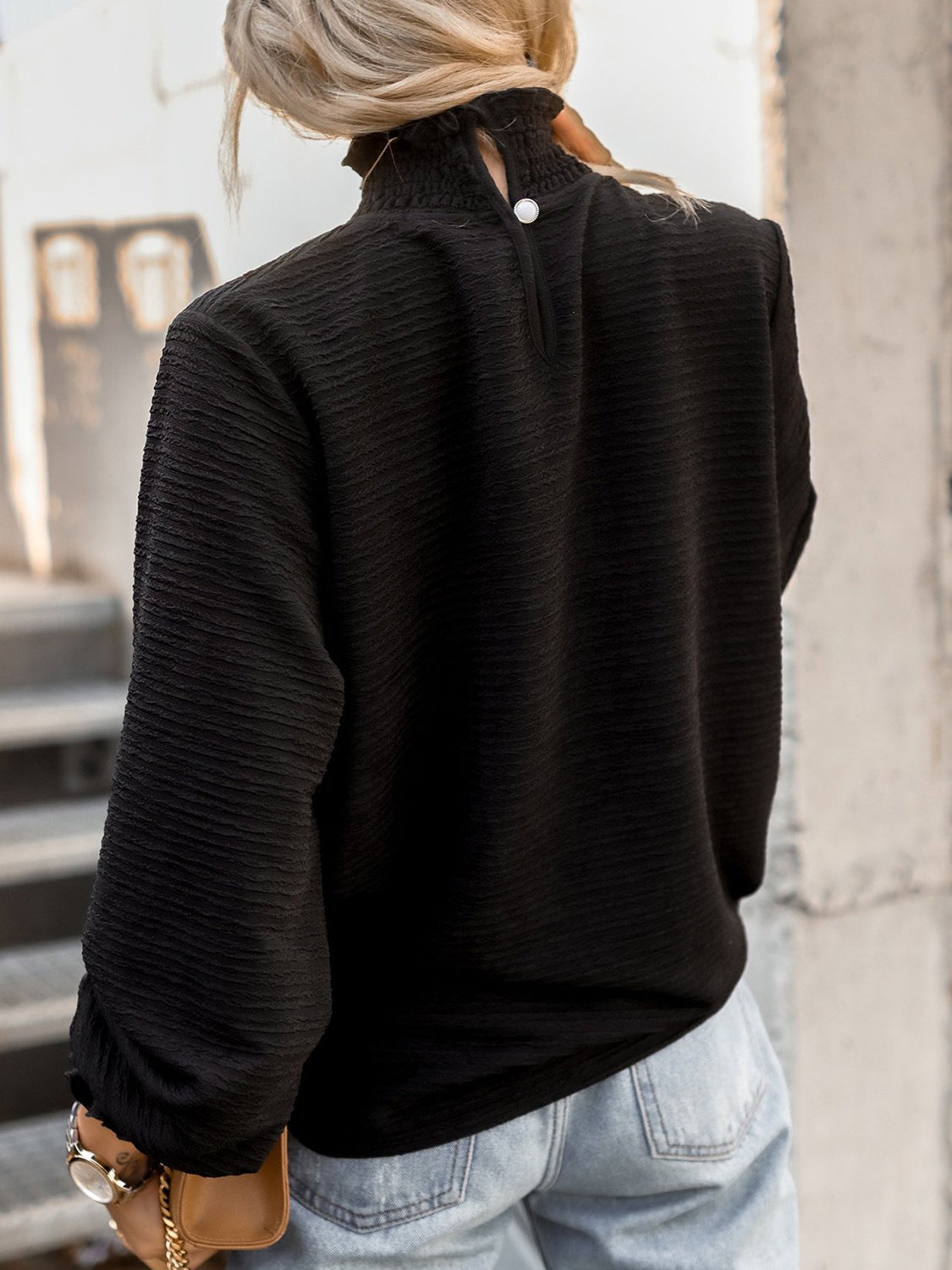 Black textured puff sleeve blouse with smocked neck and button detail