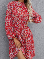 Crimson floral mini dress with gathered sleeves and high neckline.
