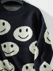 Black intarsia knit sweater with allover white smiley faces.