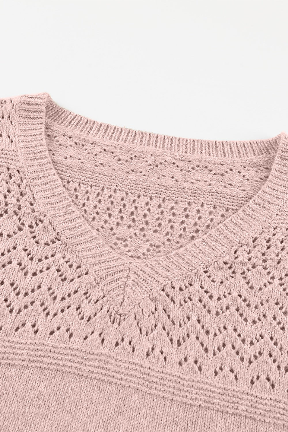 Dusty pink perforated knit V-neck pullover sweater with openwork detail.