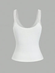 White ribbed cami with lace trim straps and neckline.