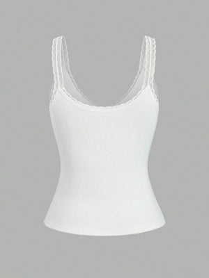White ribbed cami with lace trim straps and neckline.