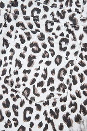 Leopard print denim shorts with frayed hem detail.