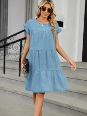 Light blue denim trapeze mini dress with ruffled sleeves and tiered skirt.