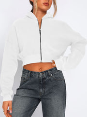 White cropped zip-up hoodie with ribbed hem detail and full zipper.