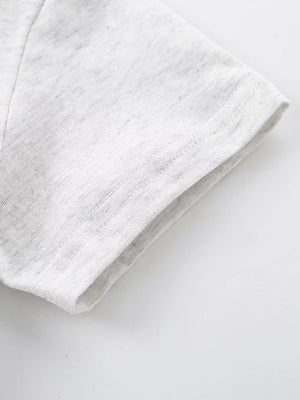 Light grey cotton t-shirt sleeve detail with stitched hem.