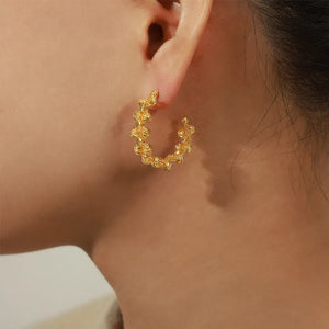 Gold textured orb C-hoop earrings with a unique beaded design.