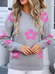 Gray crewneck knit sweater with pink floral appliqué, long sleeves, and ribbed trim.