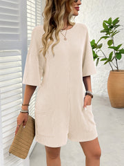 Tan ribbed knit romper with short sleeves and pockets