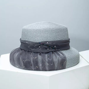 Gray wheat straw cloche sun hat with decorative ribbon and embellishments