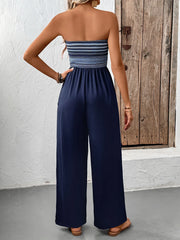 Dark blue bandeau palazzo jumpsuit with striped smocked bodice and wide legs.