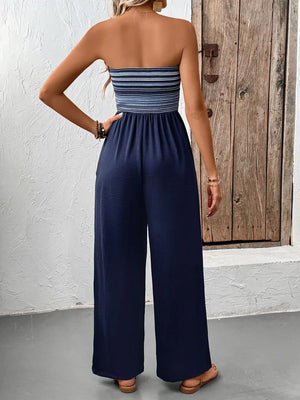 Dark blue bandeau palazzo jumpsuit with striped smocked bodice and wide legs.