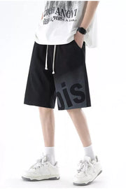 Black casual men's shorts with gradient letter detail and drawstring.