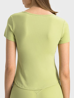 Ribbed notch-neck active t-shirt in Yellow Green with short sleeves.