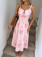 Pink floral cami midi dress with frill neckline and tie detail.