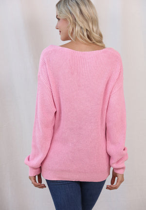Relaxed knit V-neck pullover sweater in blush pink with ribbed cuffs and hem.