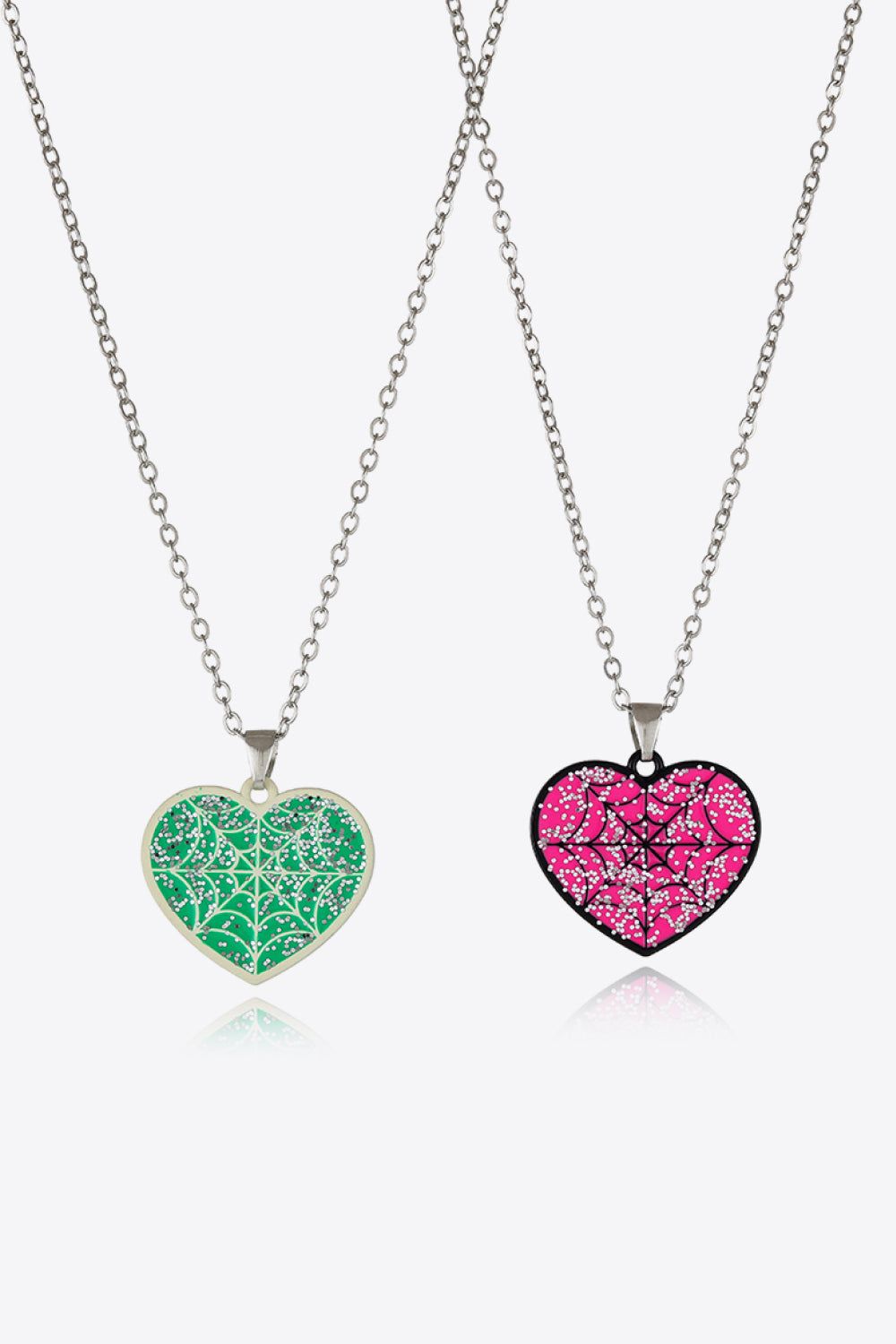 Spooky Season enamel heart pendant necklaces in green and pink with glitter spiderweb design.