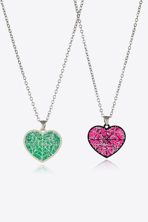 Spooky Season enamel heart pendant necklaces in green and pink with glitter spiderweb design.